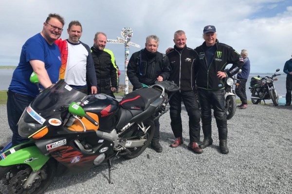 Charles Miller (left) pictured with Rob's bike and five of Charles and Rob's friends from Lancashire at John o'Groats