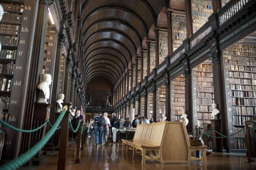 The Long Room in the Library of Trinity College Dublin with rows of books on display 