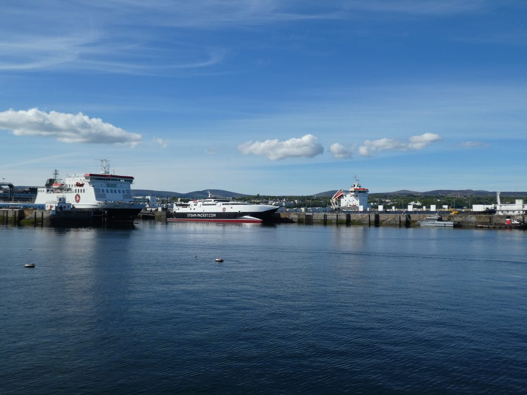 Steam Packet Company fleet in Douglas Harbour showing the blue sea  and a blue sky with a couple of clouds 