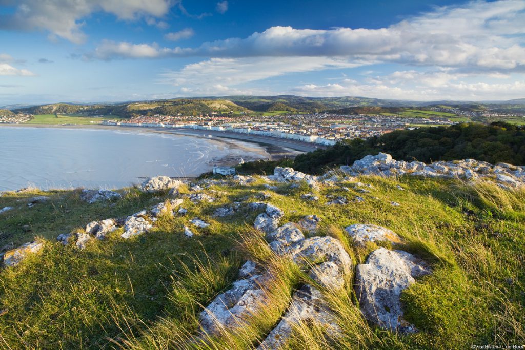 View from the top of the limestone headland ridge The Great Orme, to Llandudno historic seaside resort and waterfront in North Wales.