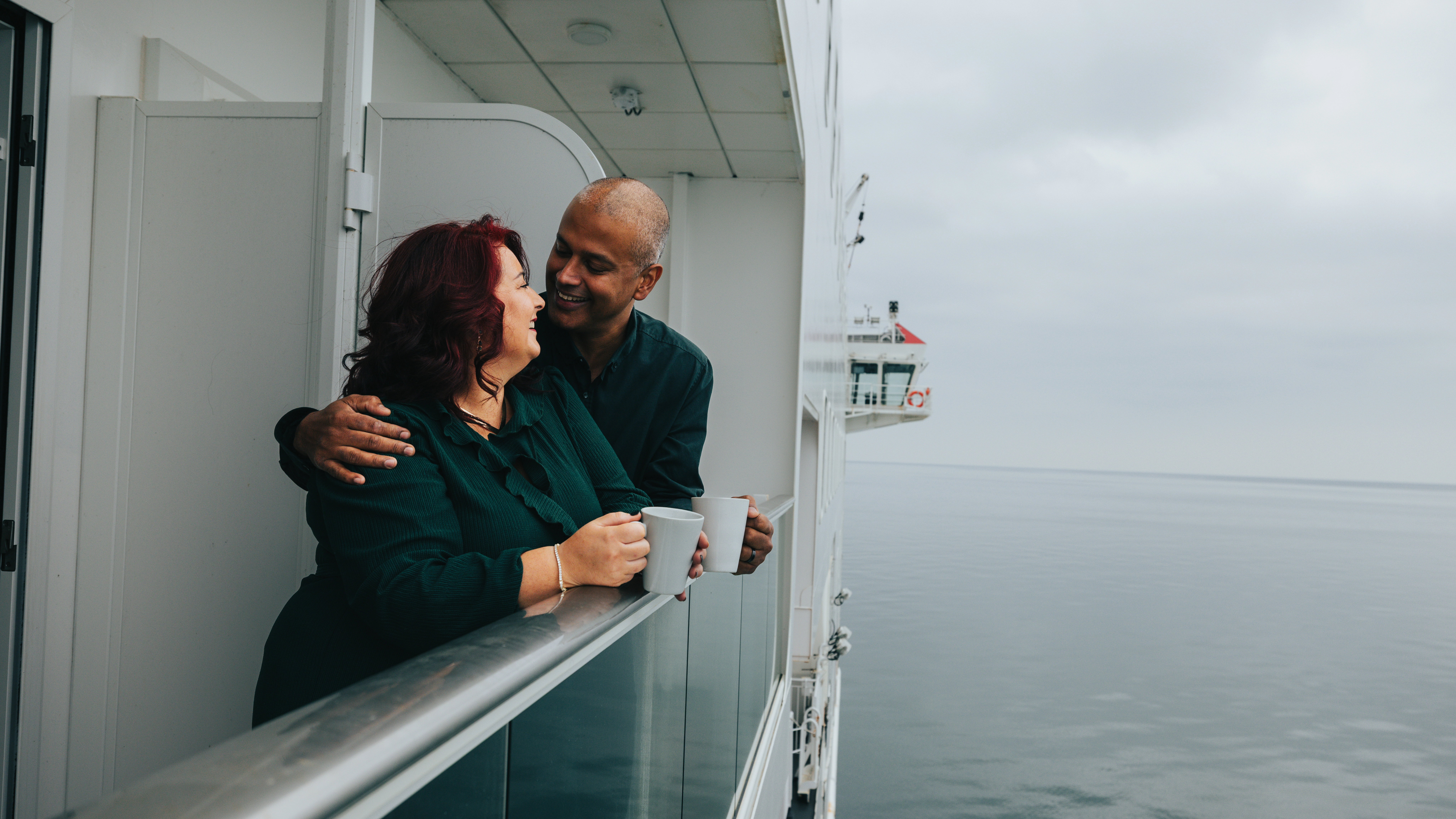 Two people on the balcony overlooking the sea on Manxman 