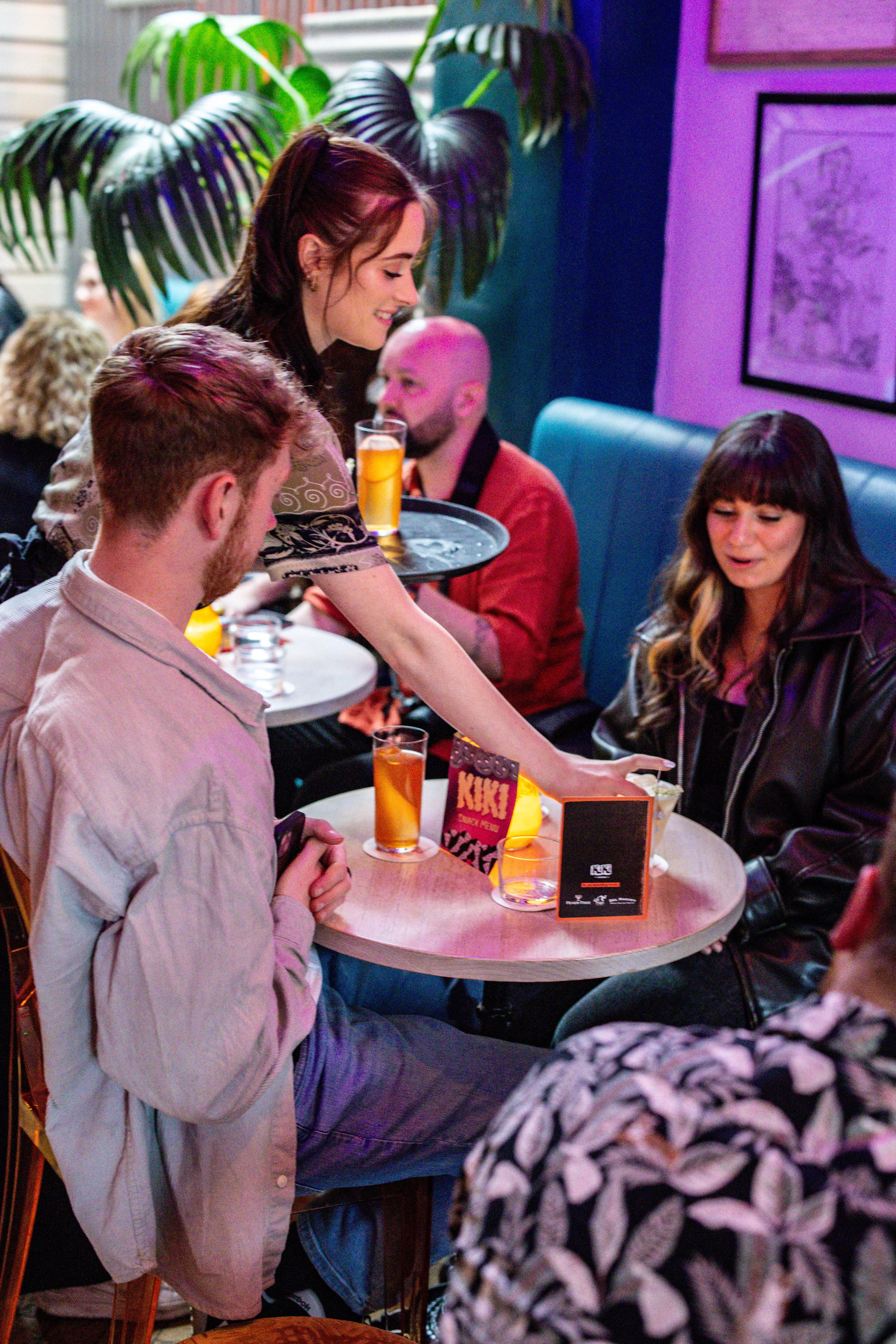 Hostess serving drinks at Kiki Lounge